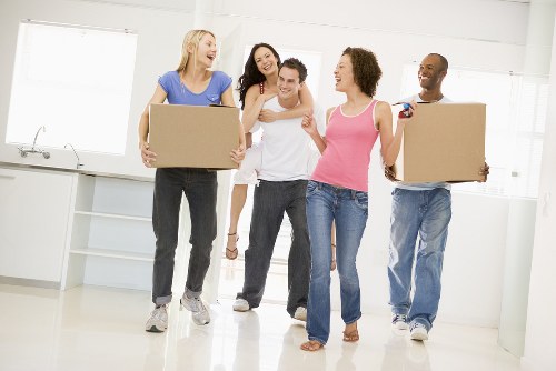 Removal team loading furniture into a moving van