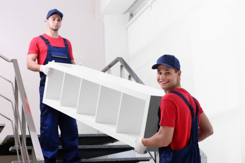 Professional removal crew loading items securely into a van