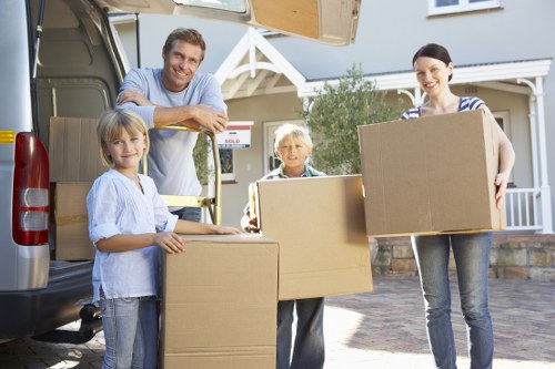 Local removalists carrying furniture through a residential property in Catford