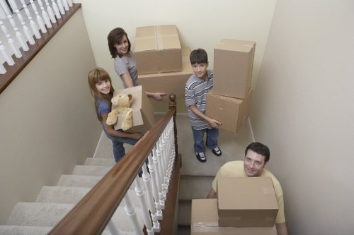 Moving team organizing boxes and furniture during a Catford relocation